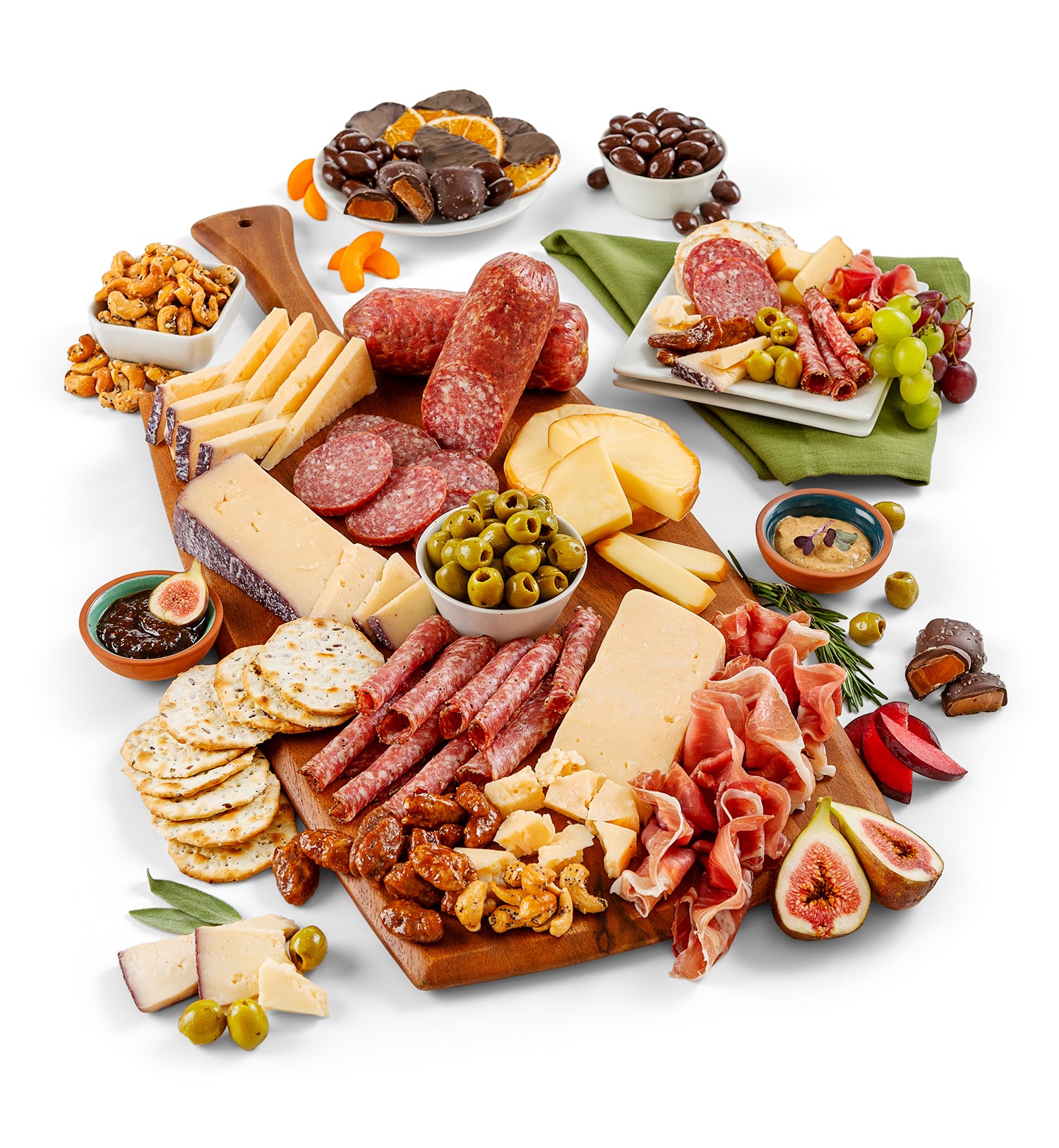 Assorted meats, cheeses, and fruits on a wooden board with a white background