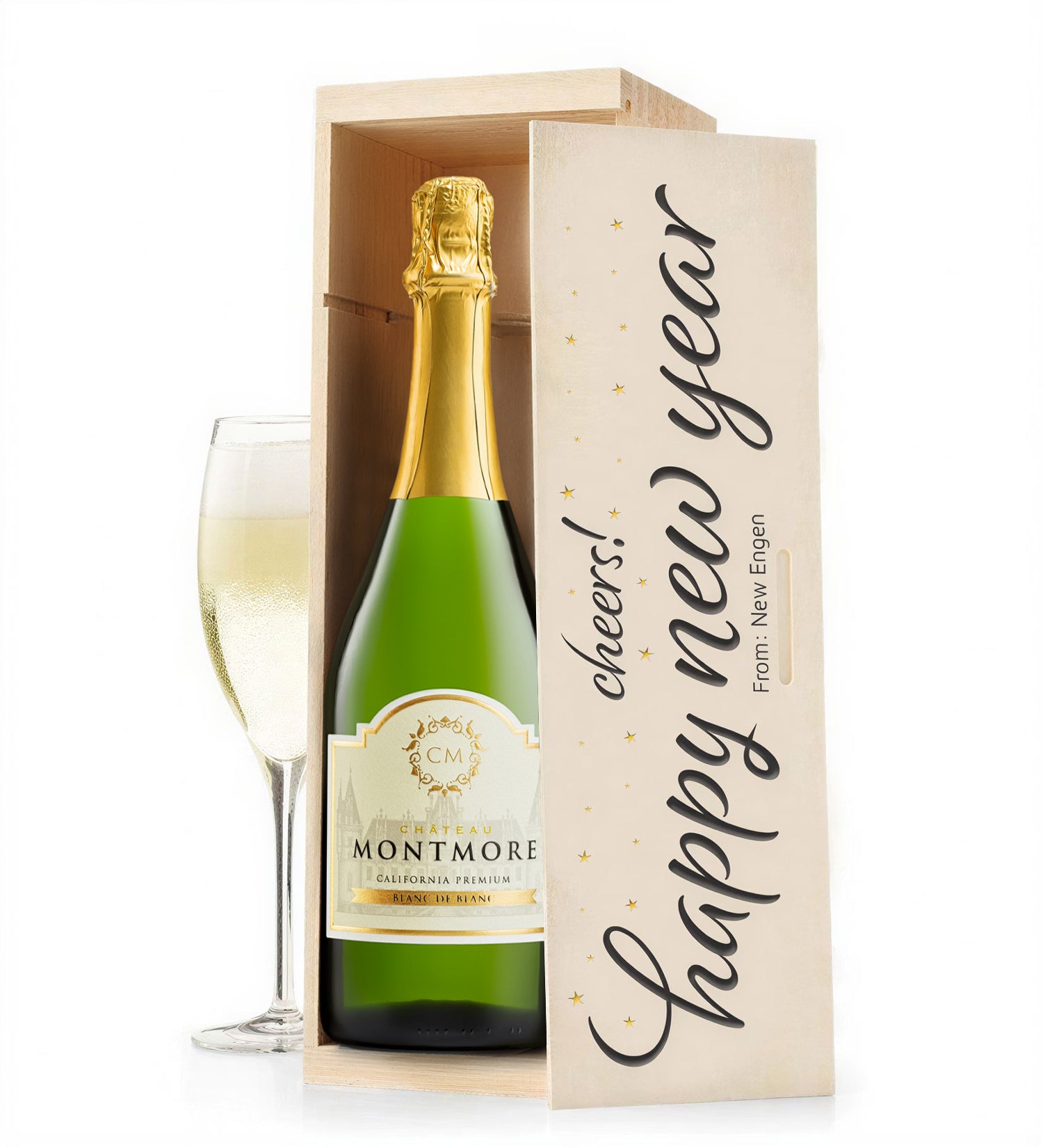 Bottle of Montmore champagne in a wooden gift box with 'Happy New Year' text, accompanied by a glass.