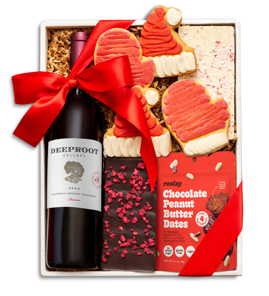 Gift set with Deeproot wine, cookies, and chocolate peanut butter dates on a white background