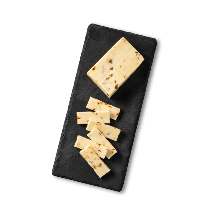 Pepperjack sliced cheese on a black slate.