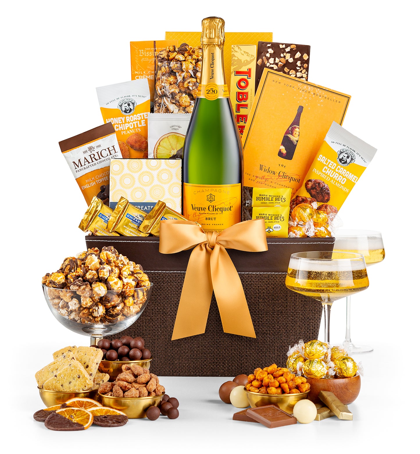 Gourmet gift basket with  Veuve Clicquot champagne, snacks, and chocolates on a white background