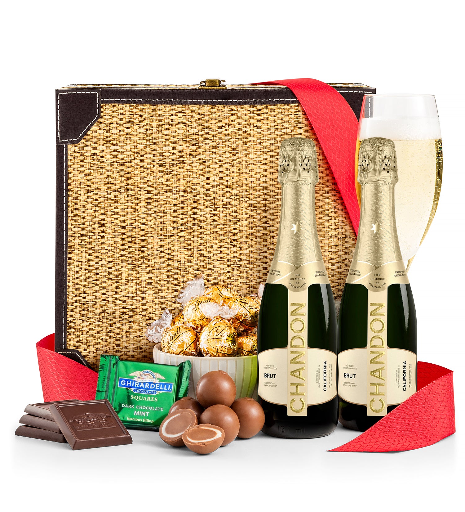 Gift basket with Chandon champagne, chocolates, and candies on a white background