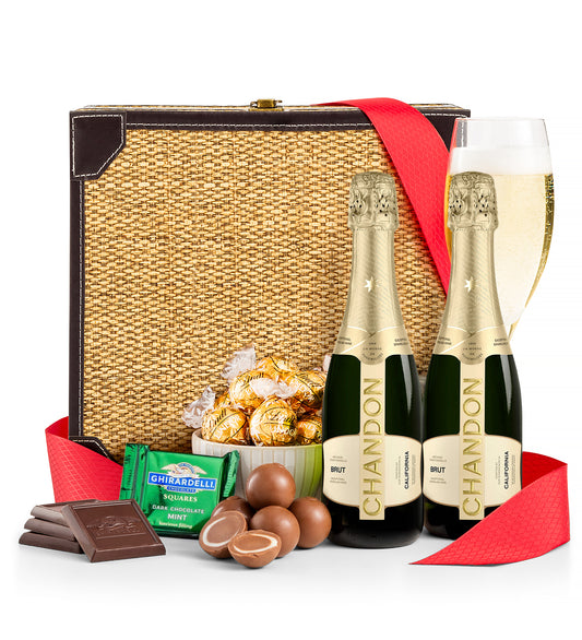 Gift basket with Chandon champagne, chocolates, and candies on a white background