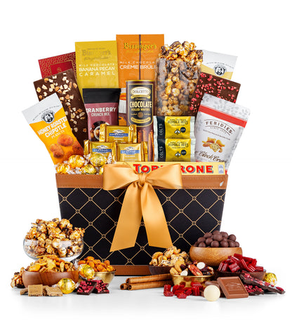 Gourmet gift basket with a variety of snacks and treats on a white background