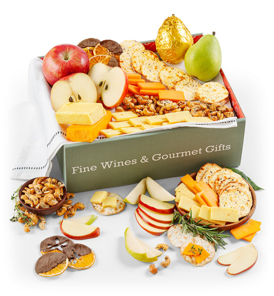 Gourmet gift box with fruits, cheese, and crackers on a white background