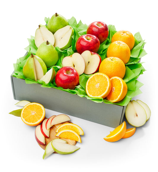 Assorted fruits including apples, oranges, and pears in a box on a white background