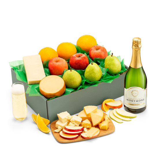 Fruit and cheese box with a bottle of chateau montmore sparkling on a white background