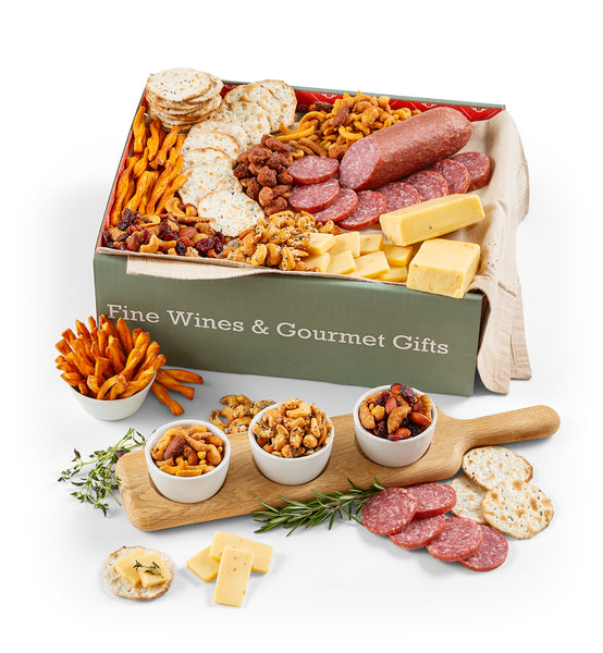 Gourmet gift box with meats, cheeses, and snacks on a white background