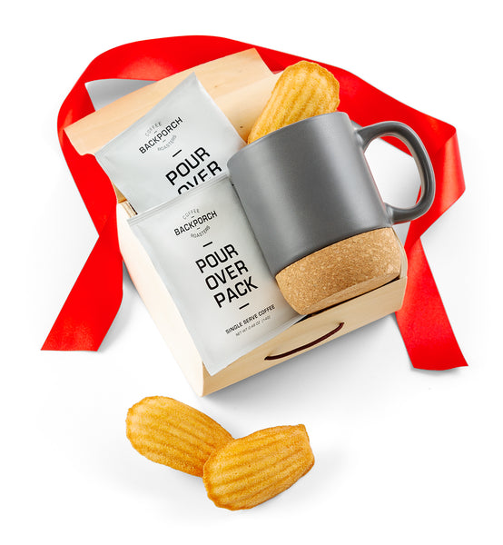 Gray mug with cork base, coffee package, and cookies on a white background