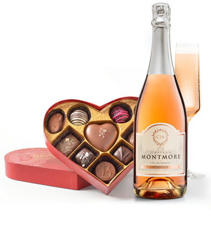 Bottle of Chateau Montmore rose wine with a heart-shaped chocolate box on a white background