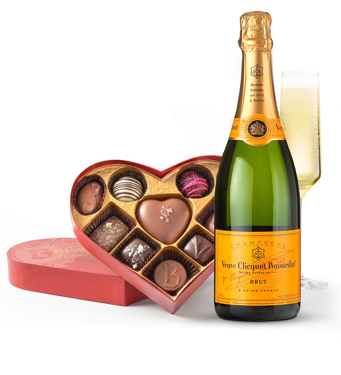 Bottle of Veuve Clicquot champagne with a heart-shaped chocolate box on a white background