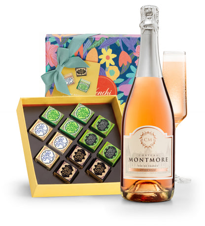 Bottle of Chateau Montmore rose wine with a box of chocolates and a glass on a white background