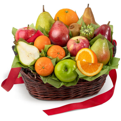 Fruit basket with apples, oranges, pears, and a red ribbon on a white background