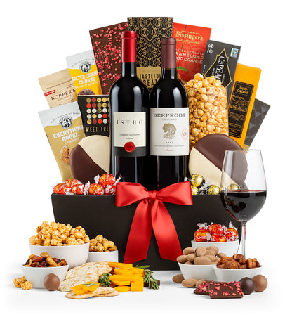 5th Avenue wine basket with snacks, and a glass of red wine on a white background