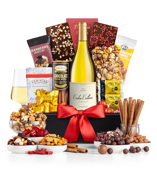 Gourmet gift basket with Calen Cellars Chardonnay, chocolates, and snacks on a white background.