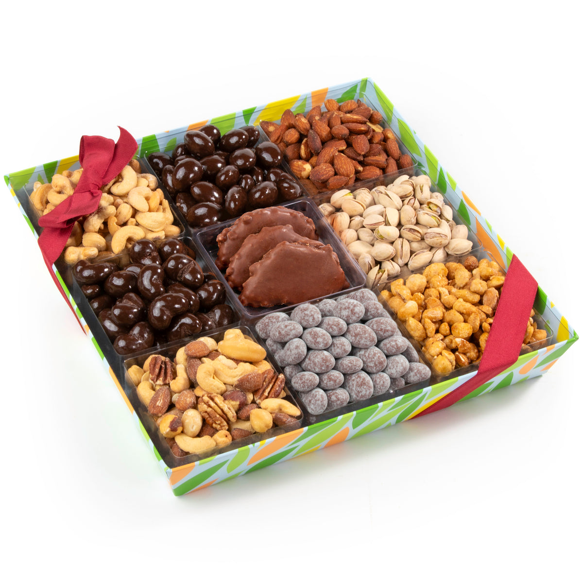 A gift box of assorted nuts and chocolates arranged in a nine-compartment black tray. The box has a colorful green, orange, and white patterned lid with a red ribbon bow.