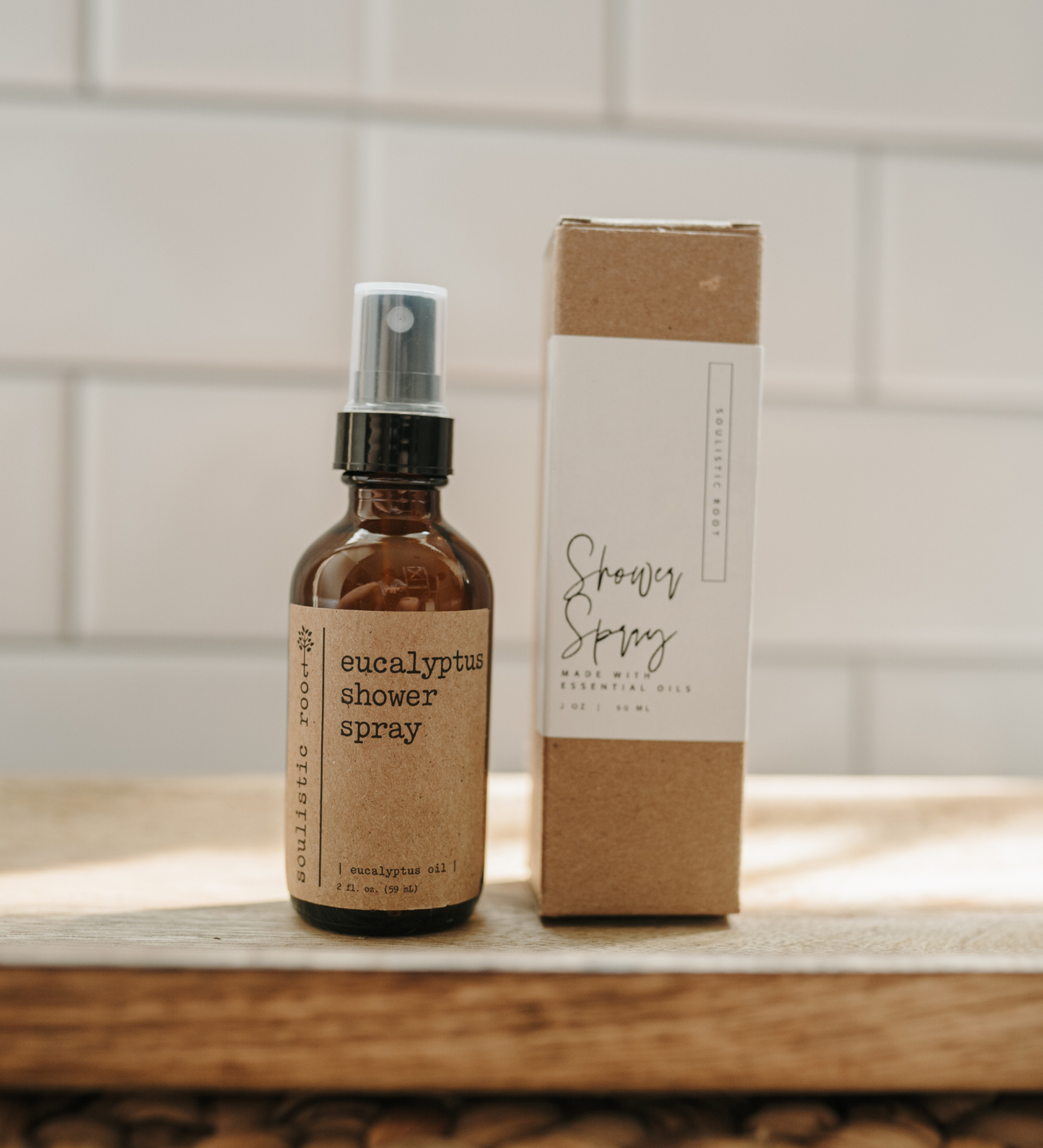 Eucalyptus shower spray bottle and box on a wooden surface with a tiled wall background