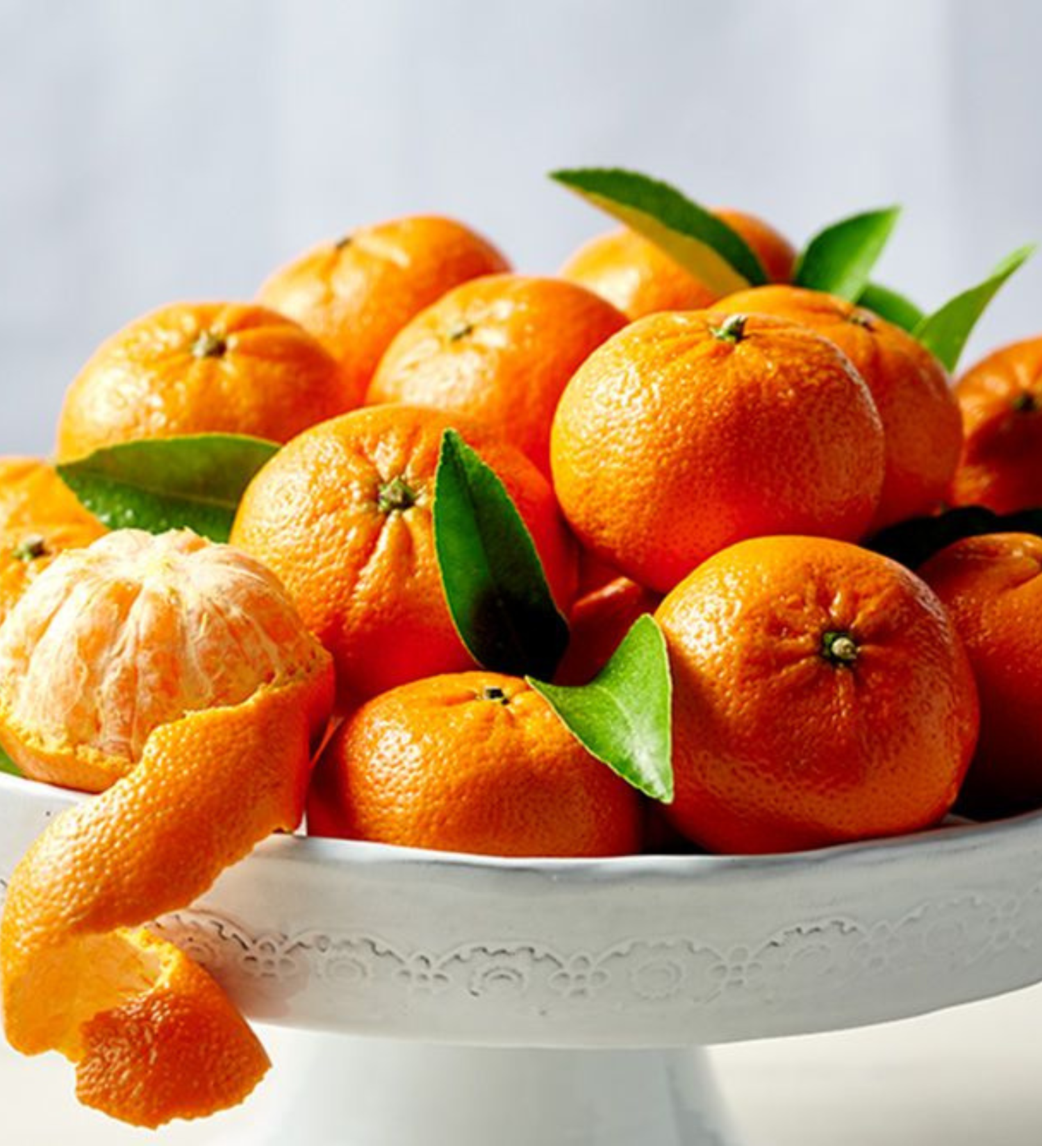 Fresh Mandarin oranges in a white bowl.