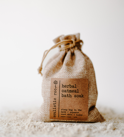Herbal oatmeal bath soak in a drawstring bag with a label on a white background