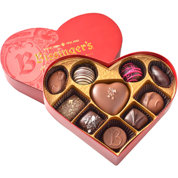 Heart-shaped Bissinger's chocolate box with various chocolates on a white background