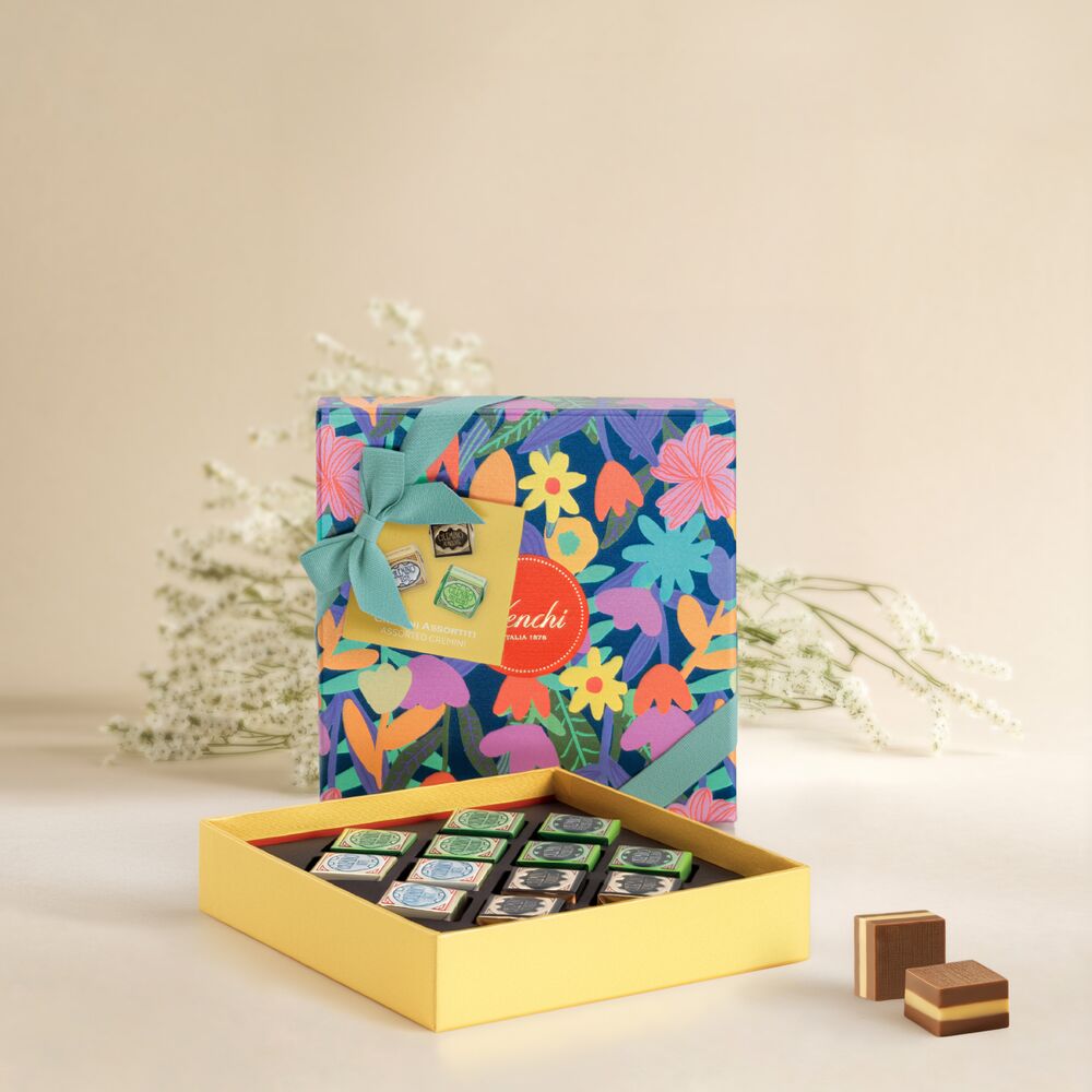 Colorful floral-patterned chocolate box with a bow, featuring Venchi Cremino Chocolate Gift Set, on a light background.