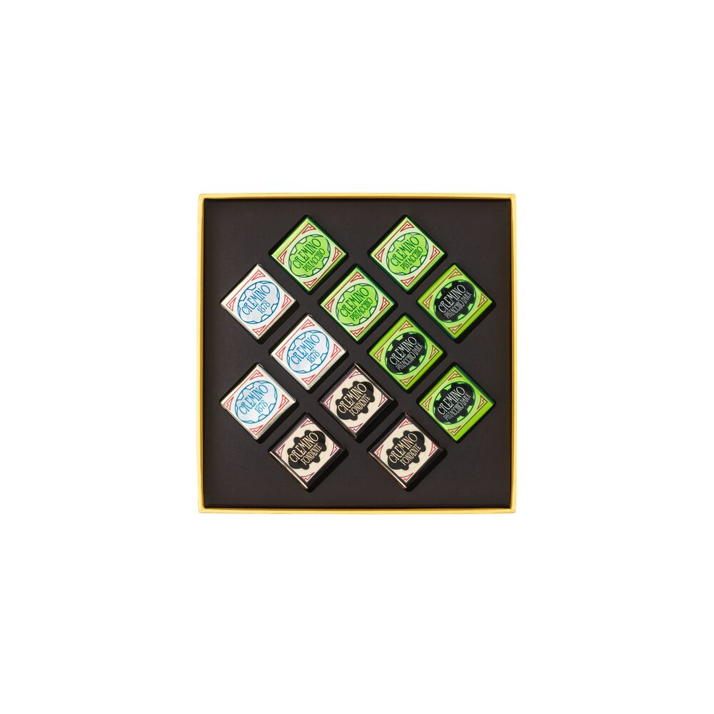 Set of nine small square stamps with green and blue designs in a black box on a white background