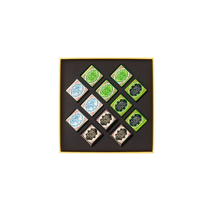 Set of nine small square stamps with green and blue designs in a black box on a white background